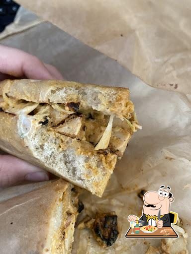 Customer photo of a cut sandwich wrapped in paper